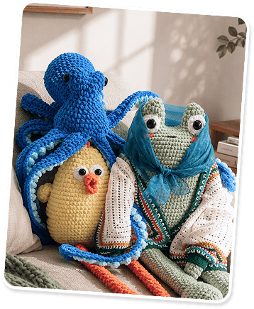 Crocheted octopus, chick and frog toys sitting together on a couch