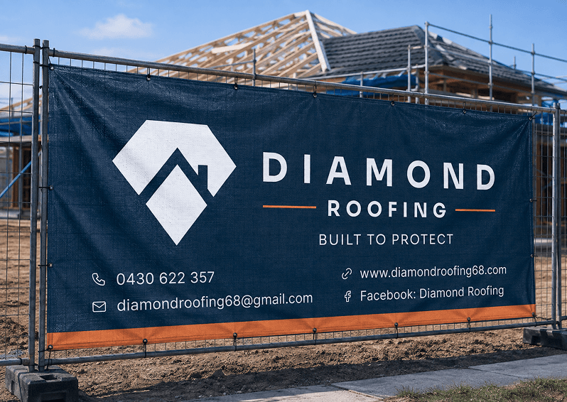 Diamond Roofing site banner on a construction fence, reading 'Built to Protect' with contact details